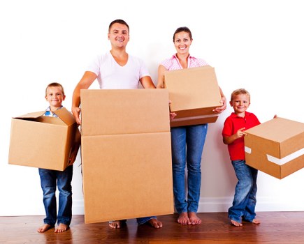 Packed moving boxes and wrapped furniture during a Fulham home relocation